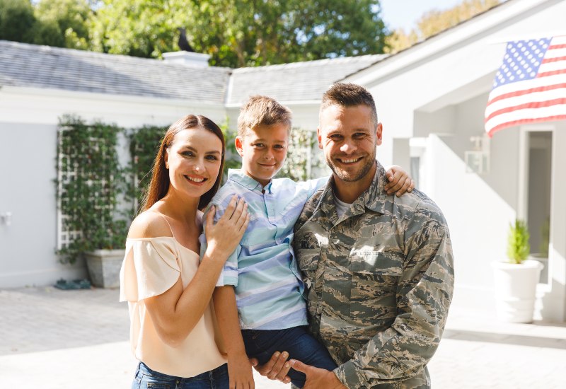 A Military Family in Tucson, AZ & Pima County, with a Man in Uniform Holding a Child
