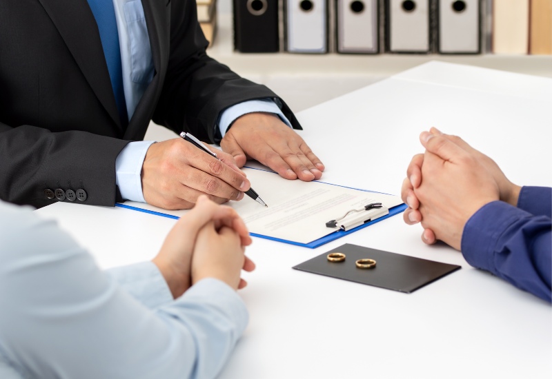 Couple Signing Divorce Papers with Lawyers in Tucson, AZ & Pima County