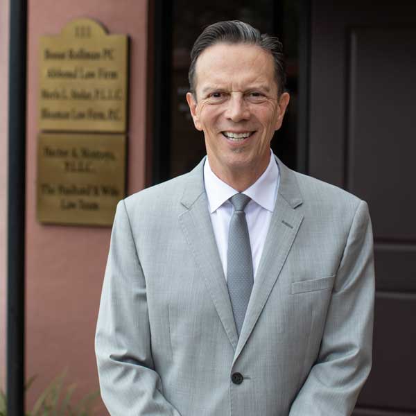 Hector A. Montoya, a lawyer outside an office offering legal representation for family law in Tucson